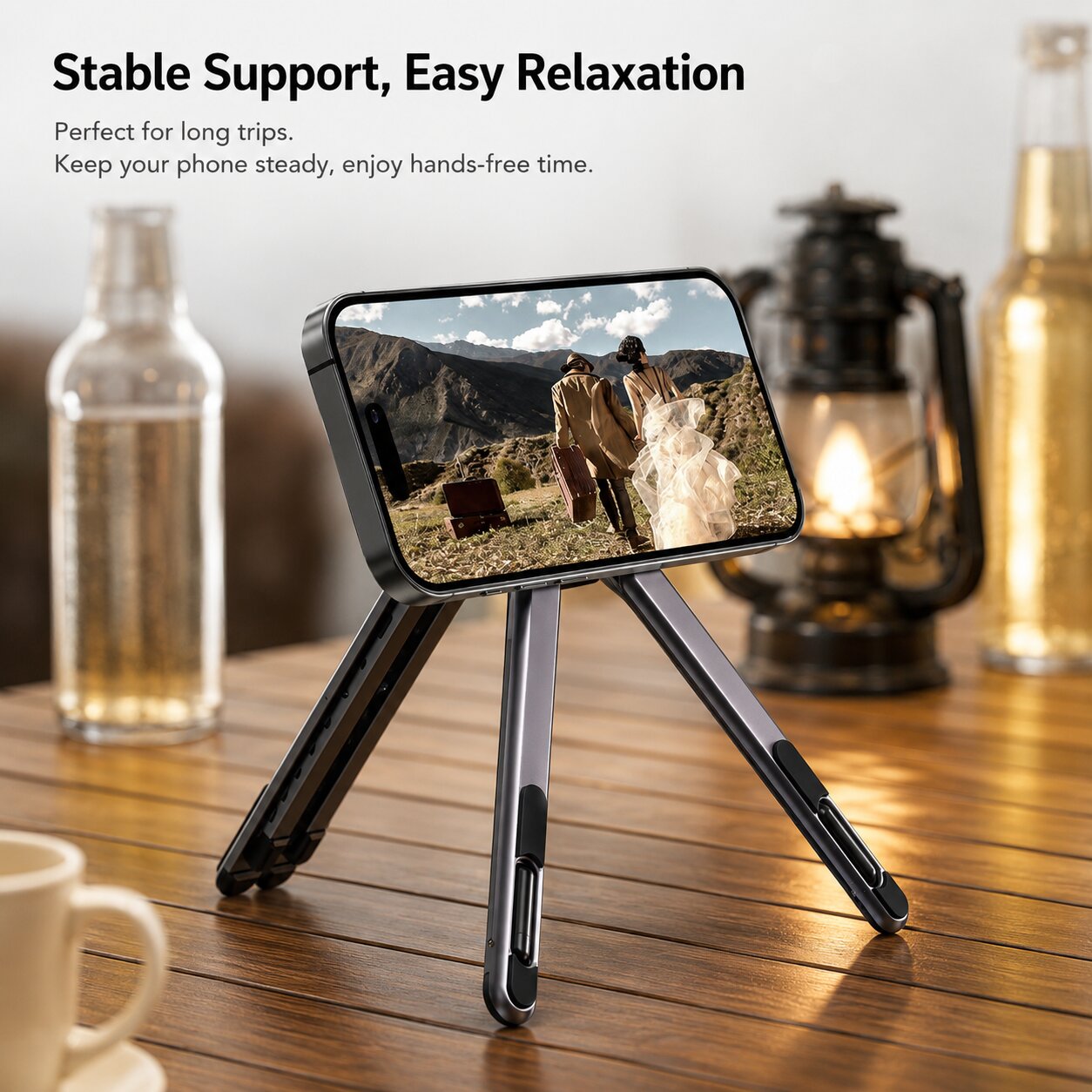 Foldable aluminum phone stand supporting a smartphone on a tabletop for hands-free video viewing, travel entertainment and comfortable media consumption.